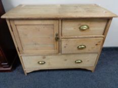 A Victorian stripped pine cabinet with three drawers