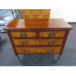 A late nineteenth century walnut four drawer chest