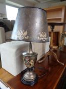 A contemporary table lamp in antique style with metal shade