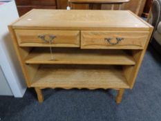 A light oak side table fitted with two drawers