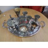 A chrome twin handled serving tray containing plated wares,