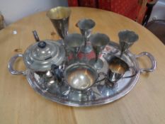 A chrome twin handled serving tray containing plated wares,
