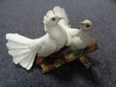 A Capo De Monte figure of a pair of doves on naturalistic plinth