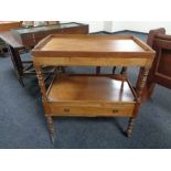 An early twentieth century mahogany butler's trolley with lift out tray