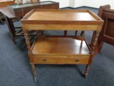 An early twentieth century mahogany butler's trolley with lift out tray