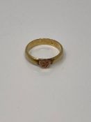 An antique yellow metal band ring with heart motif, size O, 4.2g.