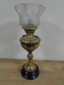 An Edwardian brass oil lamp with glass shade