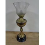 An Edwardian brass oil lamp with glass shade