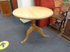 A traditional style pine pedestal table