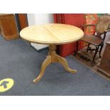 A traditional style pine pedestal table