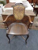 An Edwardian beech framed armchair