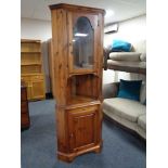 A pine glazed corner cabinet