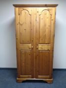 A Ducal pine double door wardrobe