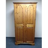 A Ducal pine double door wardrobe