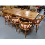 A good quality pine dining table together with a set of eight chairs