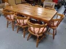 A good quality pine dining table together with a set of eight chairs