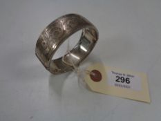 A silver bangle with safety chain, Birmingham 1961, 58.8g.