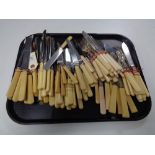 A large collection of stainless steel bladed and other cutlery.
