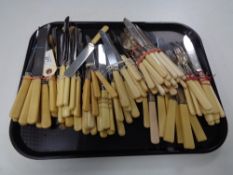 A large collection of stainless steel bladed and other cutlery.