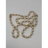 A cultured pearl necklace with 9ct gold clasp and spacers,