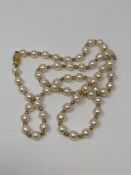 A cultured pearl necklace with 9ct gold clasp and spacers,