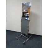 A polished steel cheval mirror