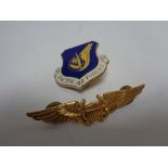 A Pacific Air force Cap badge together with a further military lapel badge (2)