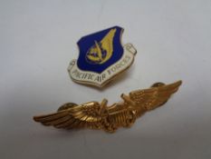 A Pacific Air force Cap badge together with a further military lapel badge (2)