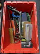 A plastic storage box containing tools, saws,