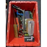A plastic storage box containing tools, saws,