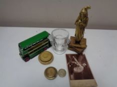 A box of antique brass figure - Scrooge, scale weights, Dinky toys bus, glass egg cup,