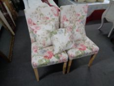 A pair of floral side chairs with three cushions