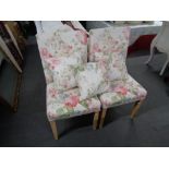 A pair of floral side chairs with three cushions