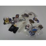 A quantity of badges, lapel pins,