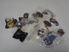 A quantity of badges, lapel pins,