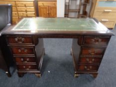 A reproduction mahogany pedestal desk with tooled leather top together with an office swivel chair