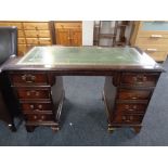 A reproduction mahogany pedestal desk with tooled leather top together with an office swivel chair