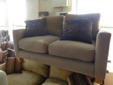 A contemporary two seater settee with scatter cushions