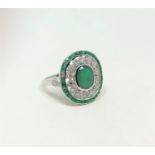 An 18ct white gold emerald and diamond Art Deco style ring,