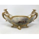 A Royal Worcester twin handled gilded table centre piece with winged-lion scrolling handles,