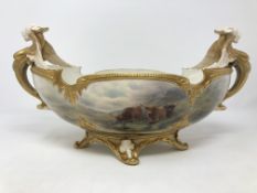 A Royal Worcester twin handled gilded table centre piece with winged-lion scrolling handles,