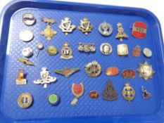 A collection of military cap badges,