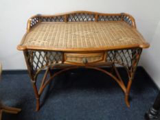 A cane side table fitted with a drawer 85 cm x 103 cm x 59.5 cm.