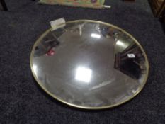 A large brass framed convex mirror, diameter 63 cm.