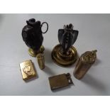 A collection of brass lighters,