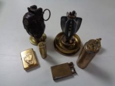 A collection of brass lighters,