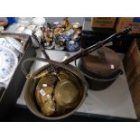 A brass jam pan together with miniature brass warming pans,