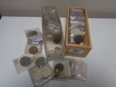 Two small boxes of coins in plastic slips,