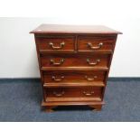 A reproduction mahogany chest of five drawers