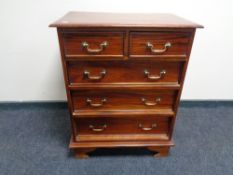 A reproduction mahogany chest of five drawers